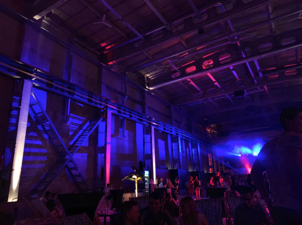 Creative event marketing case study: image of a neon-lit room with stage in distance