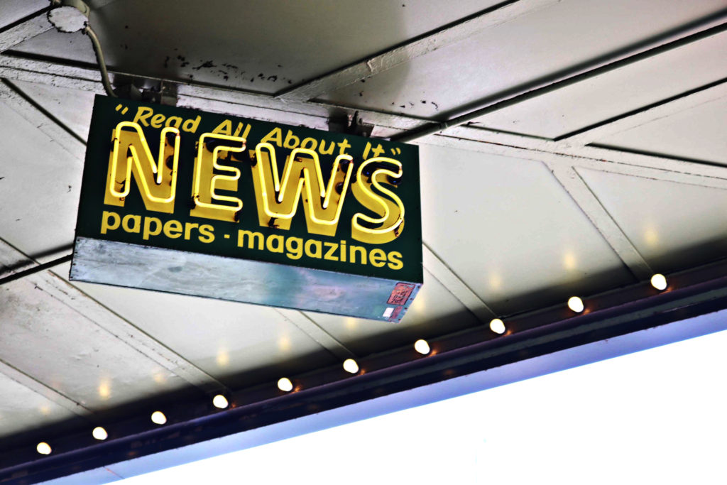 Neon sign that reads "Real All About it: News papers magazines" -- Build a public relations marketing strategy that will get you maximum media coverage.