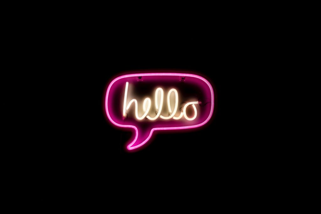 Zoom customer experience strategy is helping them crush financials in 2020: image of neon hello  in speech bubble