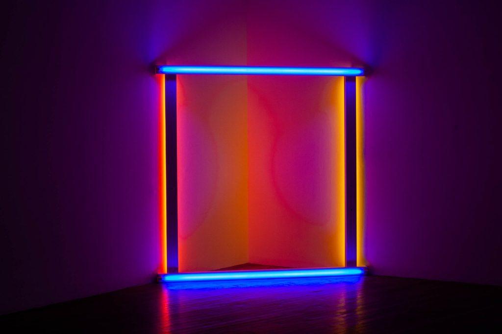A neon square in blue, orange, pink and purple - develop your freelance marketing strategy to stand out with these tips