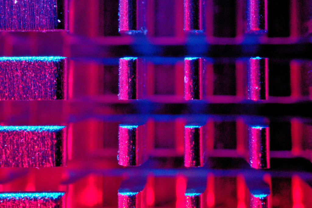 Image of inside of CPU lit with neon pink, blue and purple lighting for article is artificial intelligence better at marketing and copywriting than humans? 