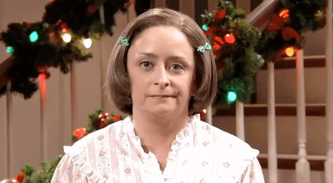 Saturday Night Live character Debbie Downer with camera zooming in on her face and Christmas decorations in the background