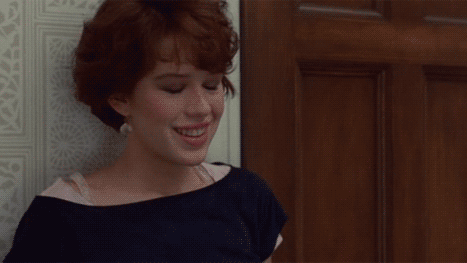 gif of Molly Ringwald in Pretty in Pink movie taking a deep sigh as her smile fades to a look of dismay