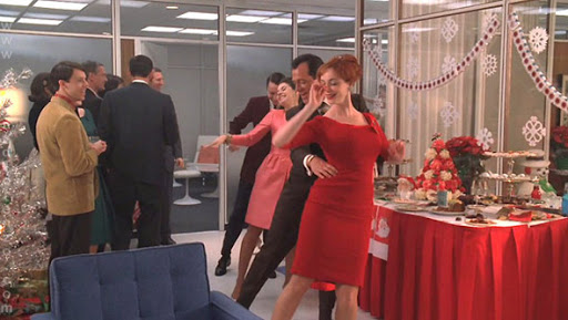 still from Mad Men with men and women at a holiday office party dancing in a conga line while others look on. Mad Men provides many classic examples of nostalgia marketing and advertising