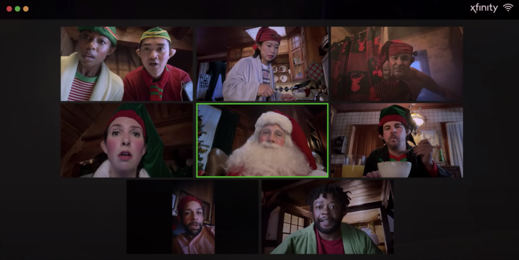 actor steve carell as santa on a zoom call with his elves; a scene from the Xfinity holiday marketing campaign 2020