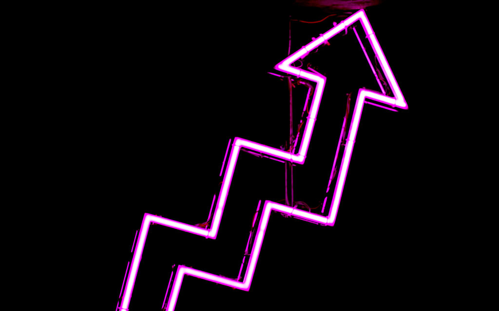 Neon pink area diagonally pointing up against black background - successful gen-z and millennial marketing strategy starts with brand evolution