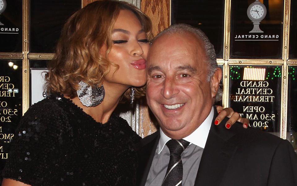 beyonce making a puckered lip face next to Sir Philip Green, chairman of arcadia group