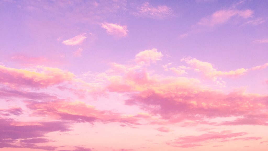 purple colored sky with pink and golden fluffy clouds spotted across it to symbolize the bright opportunities ahead for brands that leverage 2021 social media trends