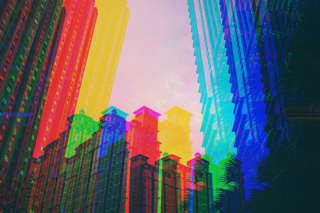 image of multi-colored buildings against a pink hue sky as banner image for article on virtual community building strategy - lessons, tips and advice